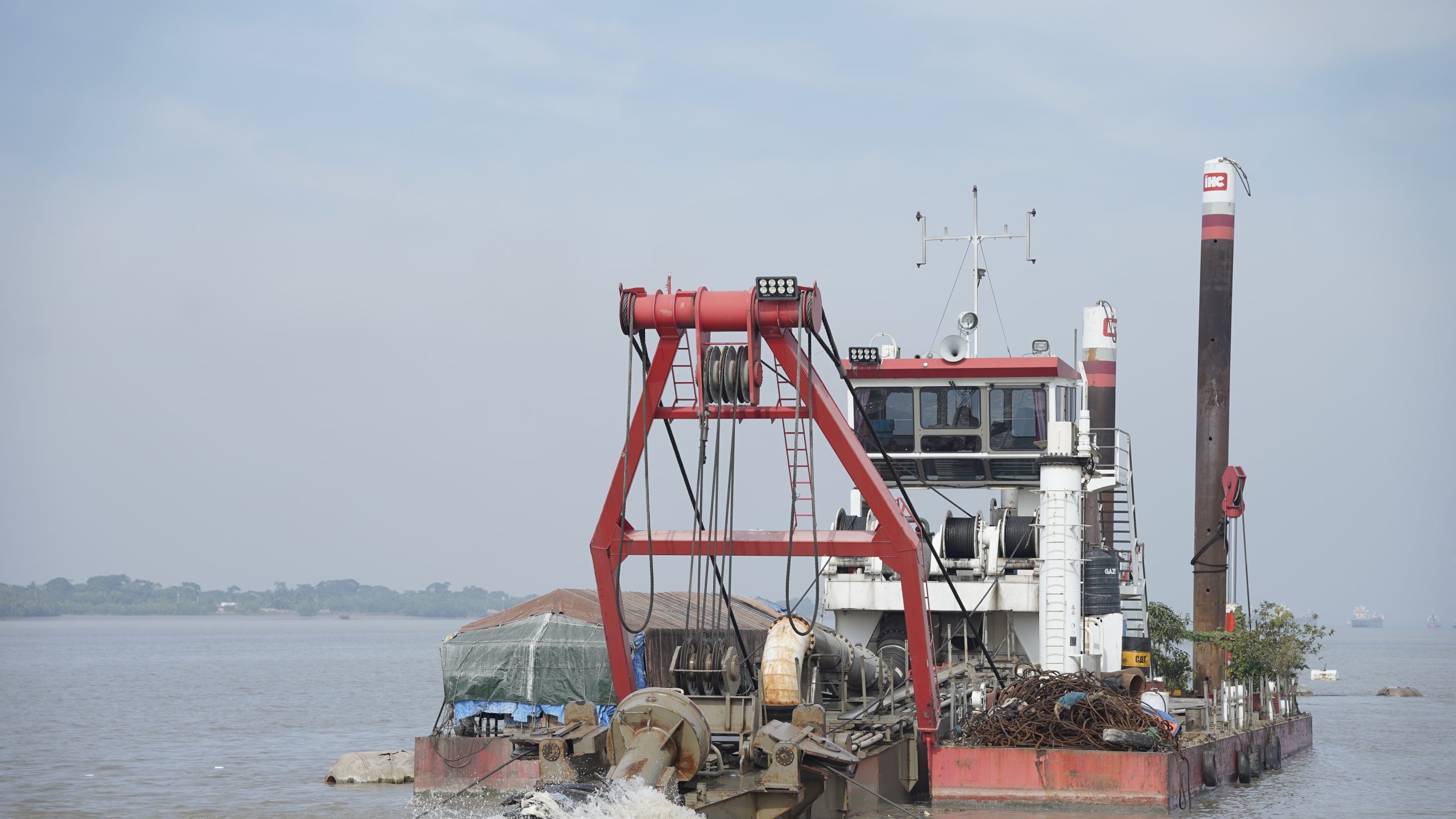 Powerful dredger excavating riverbed sediment for better water flow and infrastructure projects.
